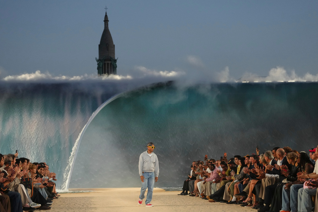 Designer Pharrell Williams accepts applause afte the Louis Vuitton men's Spring Summer 2027 collection presented in Paris, France, Tuesday, June 23, 2026. (AP Photo/Aurelien Morissard)