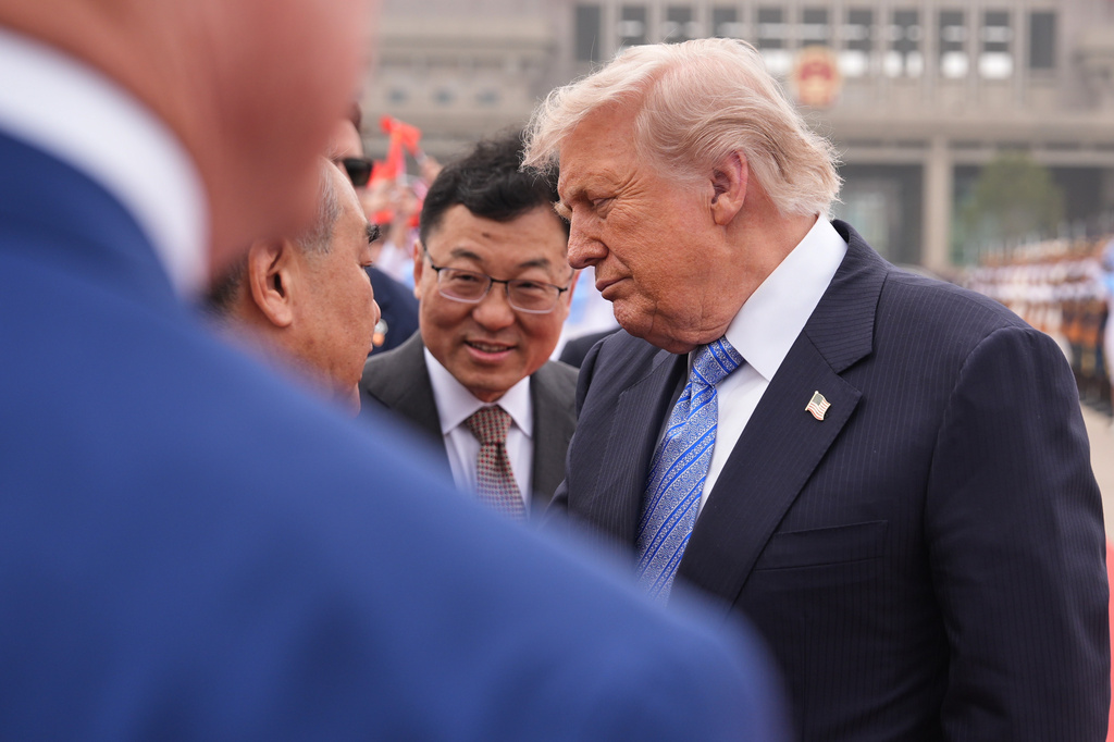 President Donald Trump interacts with China's Foreign Minister Wang Yi before boarding Air Force One, Friday, May 15, 2026, at Beijing Capital International Airport in Beijing. (AP Photo/Mark Schiefelbein)