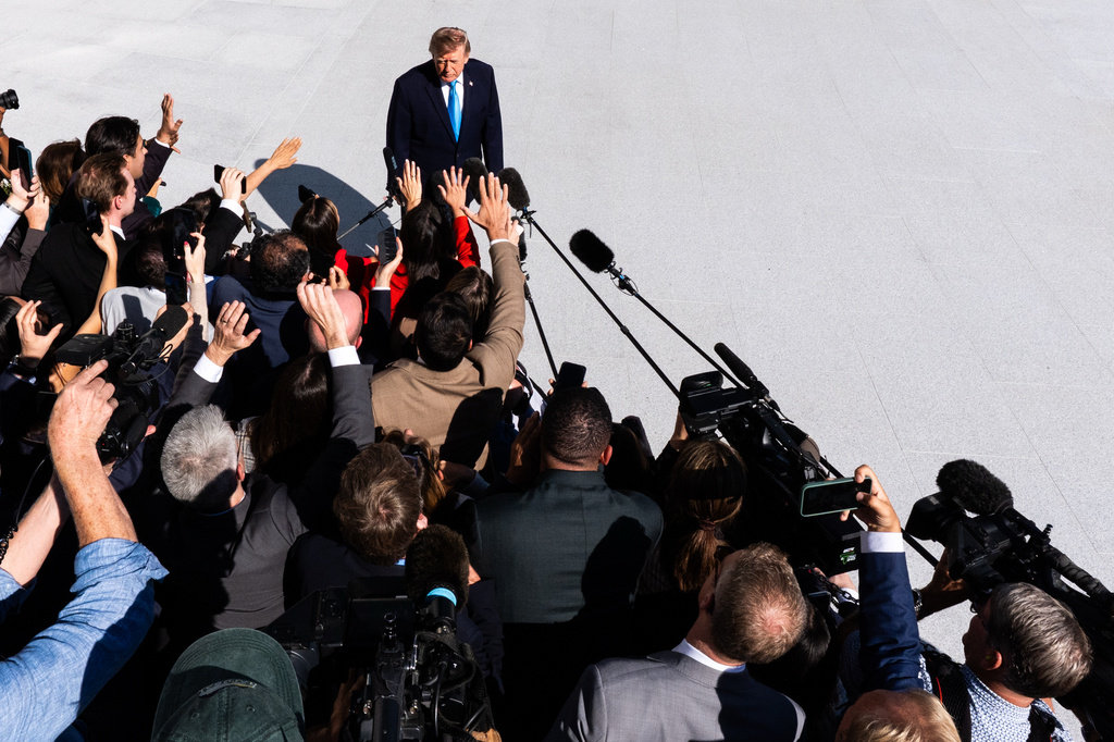 President Donald Trump talks with reporters before boarding Marine One on the South Lawn of the White House, Monday, Oct. 5, 2026, in Washington. (AP Photo/Julia Demaree Nikhinson)