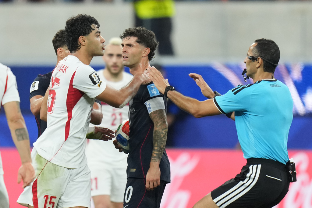 United States' Christian Pulisic, center, and Turkey's Ozan Kabak argue during the World Cup Group D soccer match in Inglewood, Calif., near Los Angeles, Thursday, June 25, 2026. (AP Photo/Andre Penner)