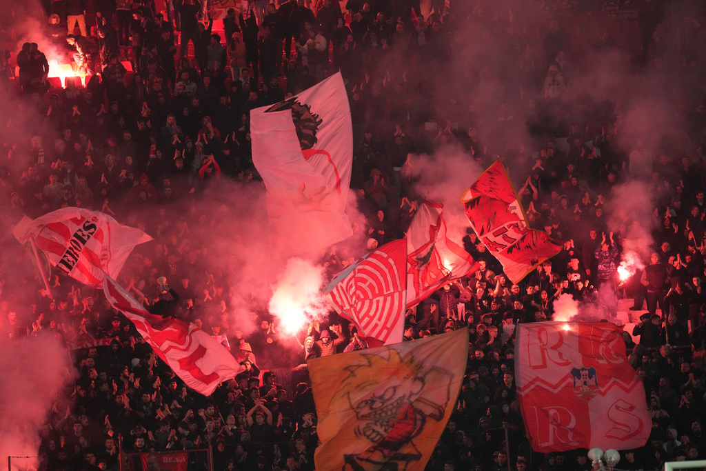 Red Star fans light torches after the second leg of the Europa League playoff soccer match between Red Star and Lille in Belgrade, Serbia, Thursday, Feb. 26, 2026. (AP Photo/Darko Vojinovic)