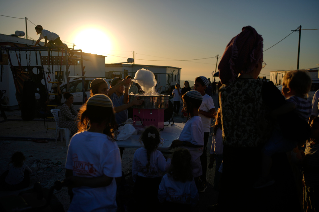 Israeli settlers gather to celebrate the inauguration of a newly built synagogue at the occupied West Bank outpost of Homesh, Wednesday, Sept. 16, 2026. (AP Photo/Ohad Zwigenberg)