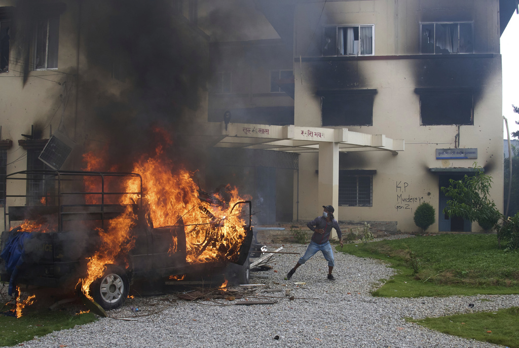Protesters vandalize and burn down Nepalese communist party office during protests against social media ban and corruption in Kathmandu, Nepal, Tuesday, Sept. 9, 2025. (AP Photo/Niranjan Shrestha)