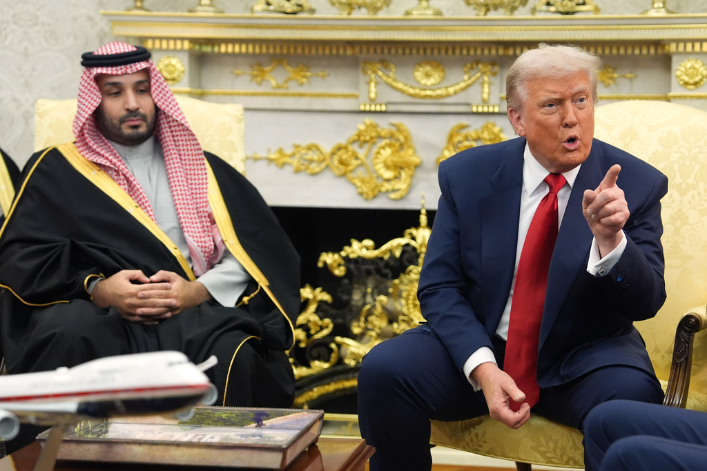 President Donald Trump points to a reporter as he meets Saudi Arabia's Crown Prince Mohammed bin Salman in the Oval Office of the White House, Tuesday, Nov. 18, 2025, in Washington. (AP Photo/Evan Vucci)