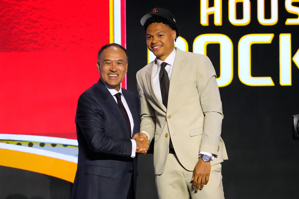 Jack Kayil, right, poses for a photo with NBA Deputy Commissioner Mark Tatum after being selected by the Houston Rockets in the second round of the NBA basketball draft Wednesday, June 24, 2026, in New York. (AP Photo/Yuki Iwamura)