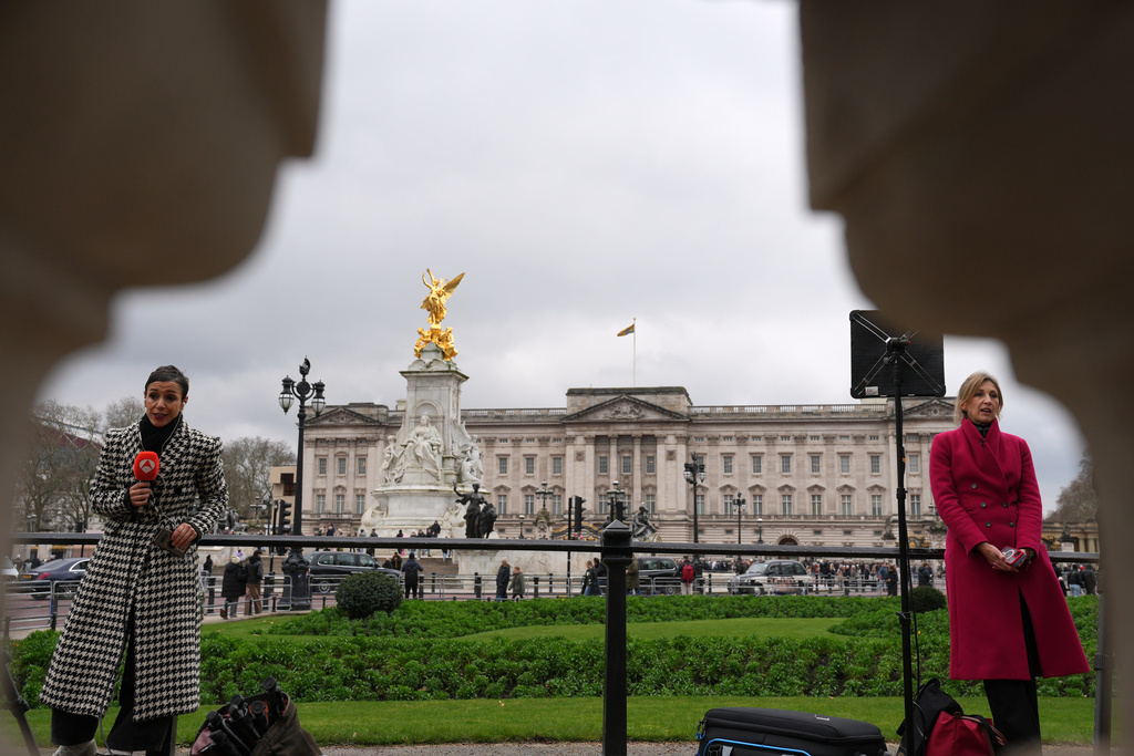 Reporters stand in front of Buckingham Palace in London, Thursday, Feb. 19, 2026 after Andrew Mountbatten-Windsor was arrested by British police on suspicion of misconduct in public office. (AP Photo/Kin Cheung)