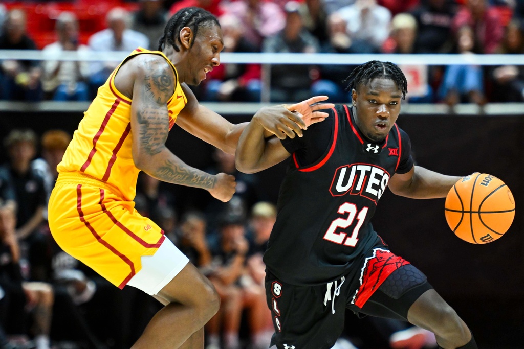 Iowa State guard Jamarion Bateman, left, defends Utah guard Obomate Abbey (21) during the first half of an NCAA college basketball game, Tuesday, Feb. 24, 2026, in Salt Lake City. (AP Photo/Alex Goodlett)