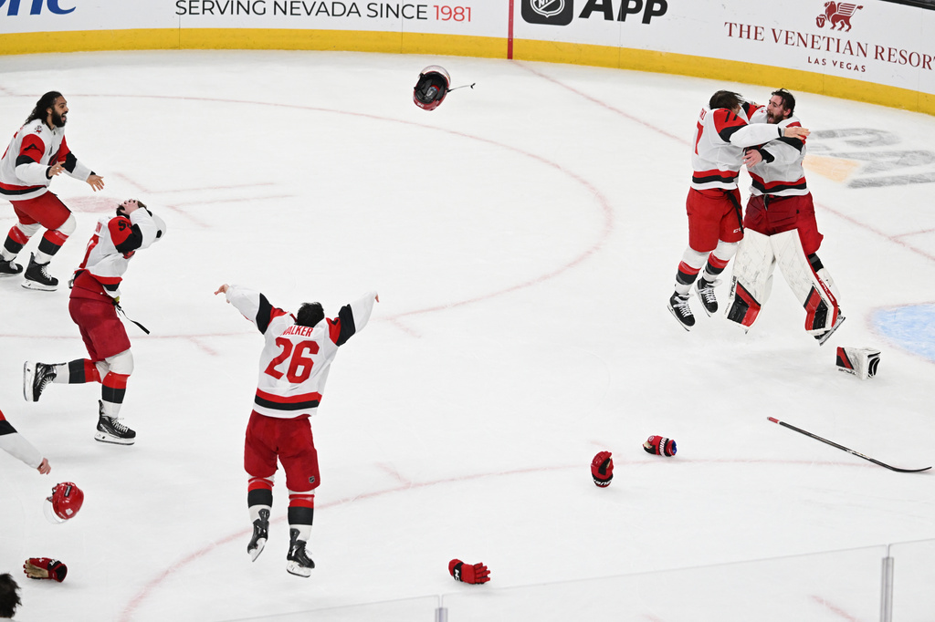 The Carolina Hurricanes celebrates after a win over the Vegas Golden Knights in Game 6 of the NHL hockey Stanley Cup Final series, Sunday, June 14, 2026, in Las Vegas. (AP Photo/Candice Ward)