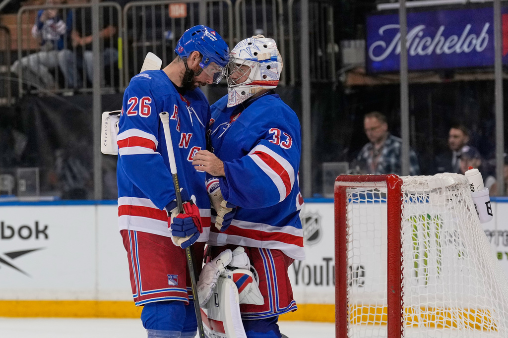 New York Rangers goaltender Dylan Garand, right, celebrates with Marcus Pettersson (26) after an NHL hockey game against the Tampa Bay Lightning in New York, Tuesday, Oct. 13, 2026. (AP Photo/Seth Wenig)