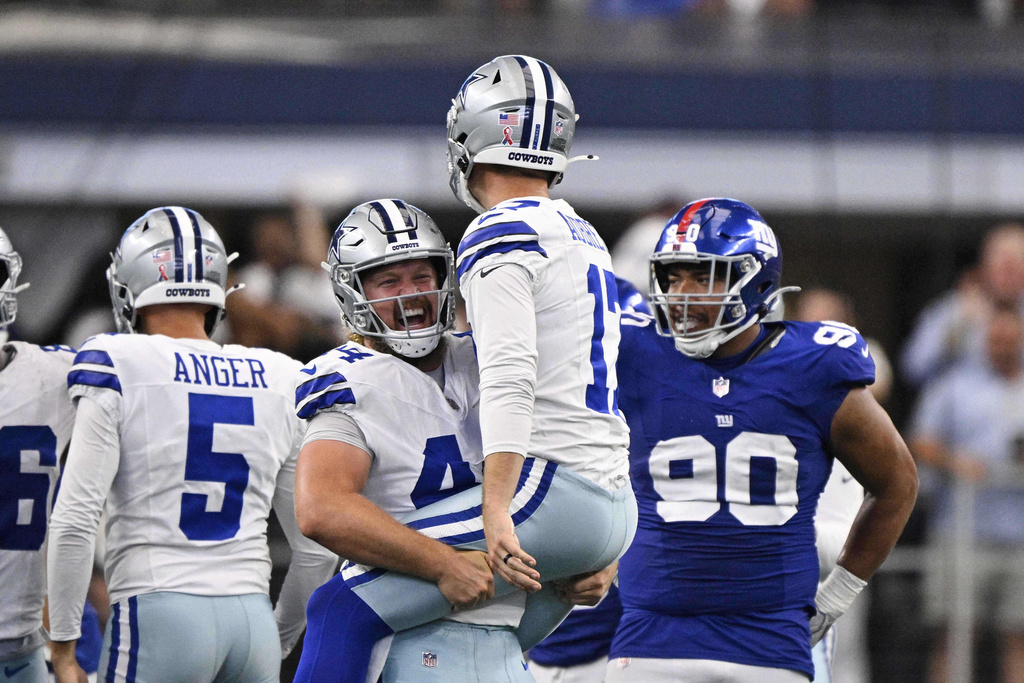Dallas Cowboys' Trent Sieg (44 and Brandon Aubrey (17) celebrate after Aubrey kicked a game-winning field goal in overtime of an NFL football game against the New York Giants Sunday, Sept. 14, 2025, in Arlington, Texas. (AP Photo/Jerome Miron)