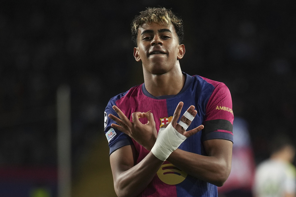 FILE - Barcelona's Lamine Yamal celebrates after scoring his side's second goal during the Champions League round of 16 second leg soccer match between FC Barcelona and SL Benfica at the Lluis Companys Olympic Stadium in Barcelona, Spain, Tuesday, March 11, 2025. (AP Photo/Emilio Morenatti, File)