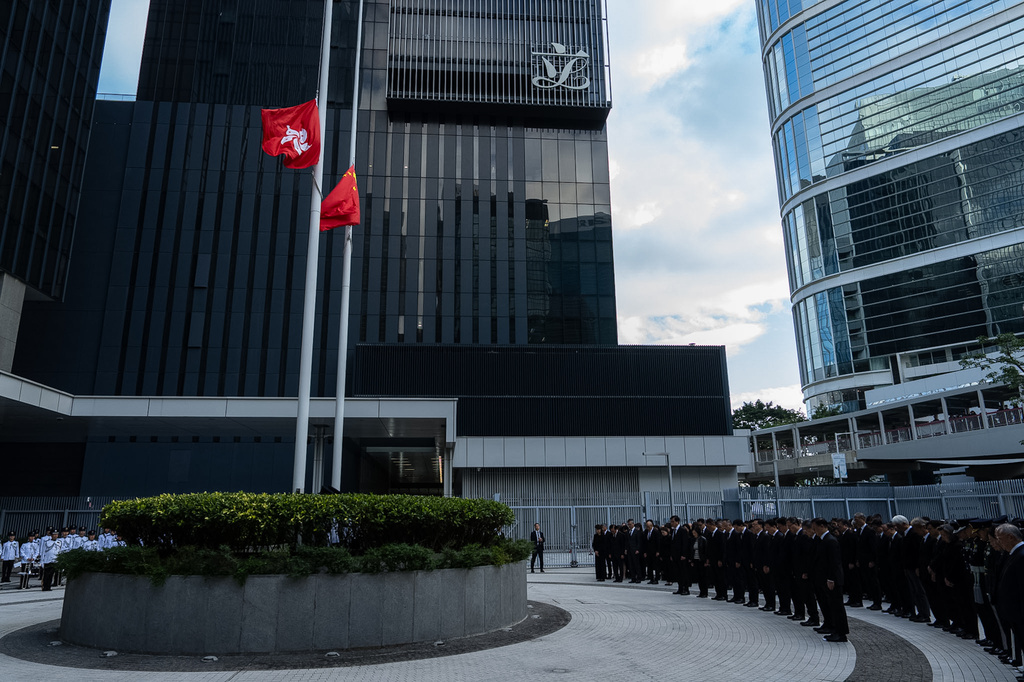 Chinese and Hong Kong Special Administrative Region flags fly at half-mast to mourn the victims of the deadly fire that started Wednesday at Wang Fuk Court, a residential estate in the Tai Po district of Hong Kong's New Territories, Saturday, Nov. 29, 2025. (AP Photo/Chan Long Hei)