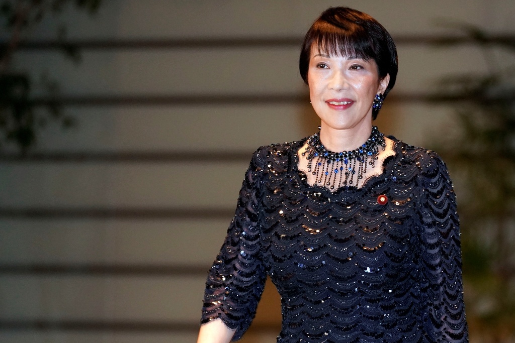 FILE - Sanae Takaichi, newly appointed Internal Affairs and Communications minister, enters the prime minister's official residence in Tokyo, Sept. 11, 2019. (AP Photo/Eugene Hoshiko, File)