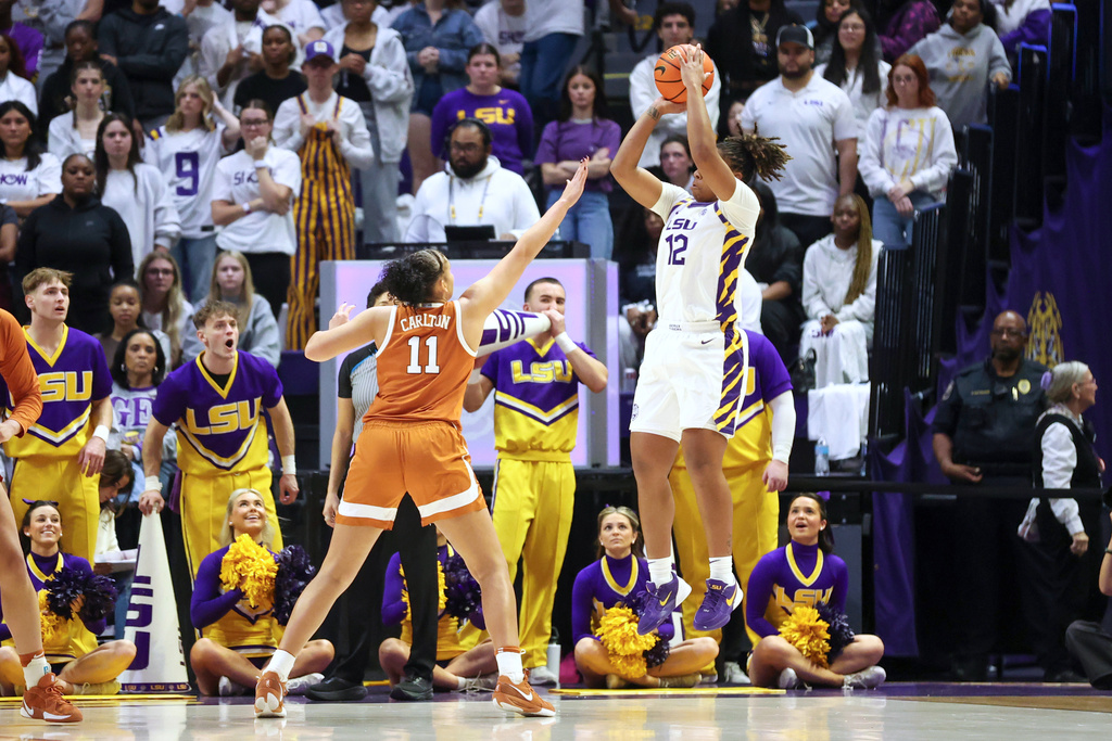 LSU guard Mikaylah Williams shoots a jumper over Texas forward Justice Carlton (11) in the first half of an NCAA college basketball game in Baton Rouge, La., Sunday, Jan. 11, 2026. (AP Photo/Peter Forest)