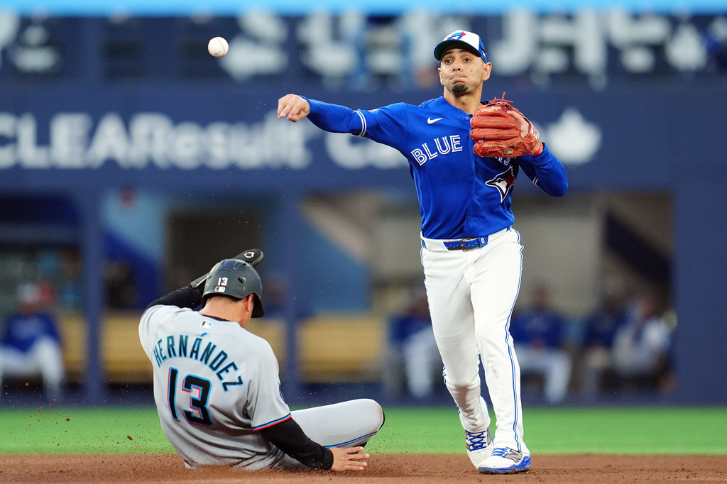 Toronto Blue Jays' shortstop Andrés Giménez (0) forces an out on Miami Marlins' Heriberto Hernandez (13) during fifth inning of a baseball game in Toronto on Tuesday May 26, 2026. (Frank Gunn/The Canadian Press via AP)