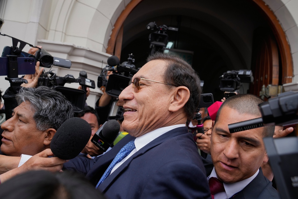 FILE - Former President Martin Vizcarra, who is facing corruption charges, is surrounded by a media gaggle as he leaves a courthouse after attending his trial, in Lima, Peru, Nov. 20, 2025. (AP Photo/Martin Mejia, File)