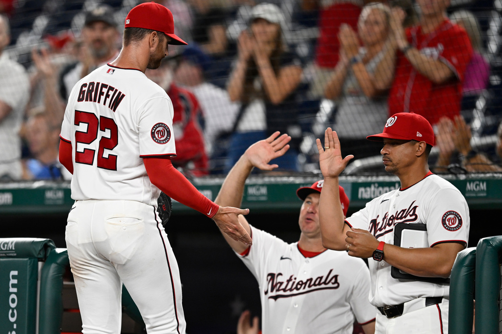 Washington Nationals starting pitcher Foster Griffin is greeted at the dugout after being taken out the game during the 8th inning of a baseball game against the Philadelphia Phillies, Monday, June 22, 2026, in Washington. (AP Photo/John McDonnell)