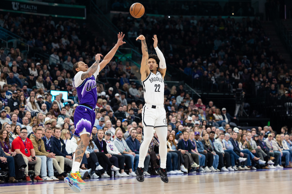 Brooklyn Nets forward Jalen Wilson (22) shoots over Utah Jazz guard Keyonte George, left, during the first half of an NBA basketball game, Friday, Jan. 30, 2026, in Salt Lake City. (AP Photo/Anna Fuder)