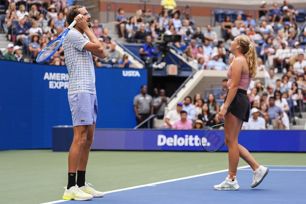 Daniil Medvedev, left, and his partner Mirra Andreeva react during a mixed doubles match at the U.S. Open tennis championships, Tuesday, Aug. 19, 2025, in New York. (AP Photo/Yuki Iwamura)