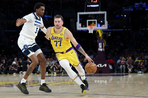Los Angeles Lakers guard Luka Doncic (77) dribbles against the Minnesota Timberwolves forward Jaden McDaniels (3) during the first half of an NBA basketball game, Friday, Oct. 24, 2025, in Los Angeles. (AP Photo/Jessie Alcheh) Los Angeles Lakers guard Luka Doncic (77) dribbles against the Minnesota Timberwolves forward Jaden McDaniels (3) during the first half of an NBA basketball game, Friday, Oct. 24, 2025, in Los Angeles. (AP Photo/Jessie Alcheh)
