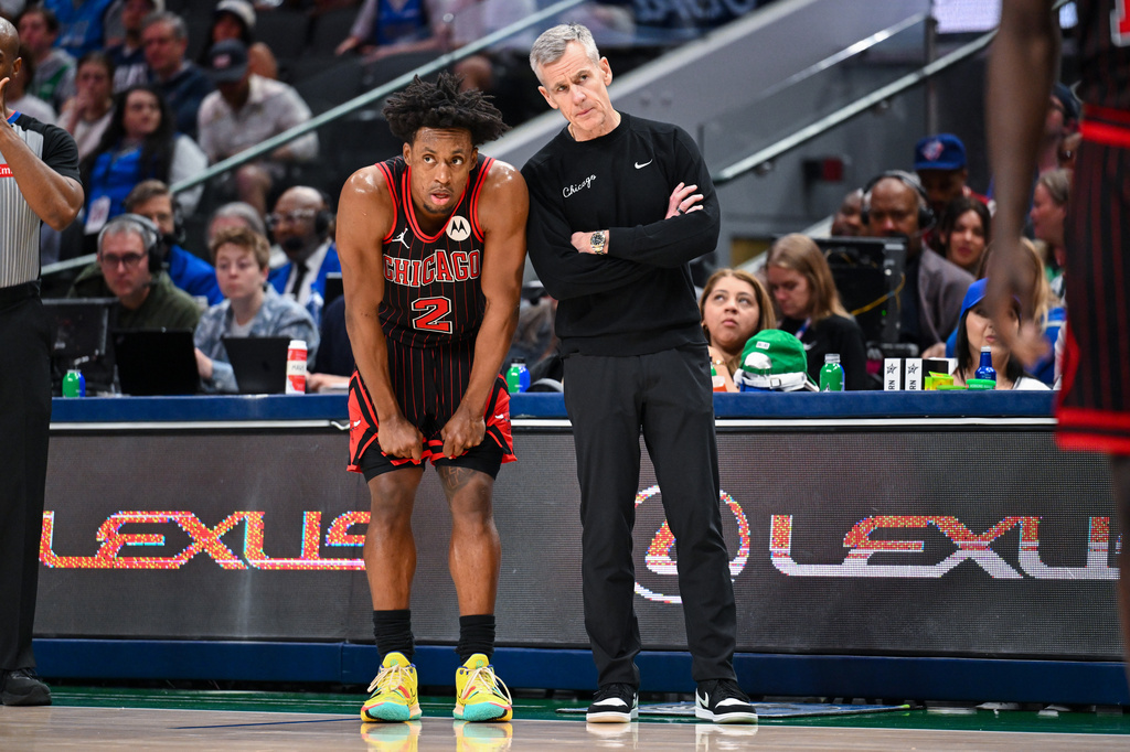 Chicago Bulls' Collin Sexton talks with Chicago Bulls head coach Billy Donovan during a time out in an NBA basketball game against the Dallas Mavericks Sunday, April 12, 2026, in Dallas. (AP Photo/Albert Pena)
