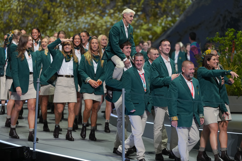 Members of the Australian team reacts as the walk on stage during the Commonwealth Games opening ceremony in Glasgow, Scotland, Thursday, July 23, 2026. (AP Photo/Kin Cheung)