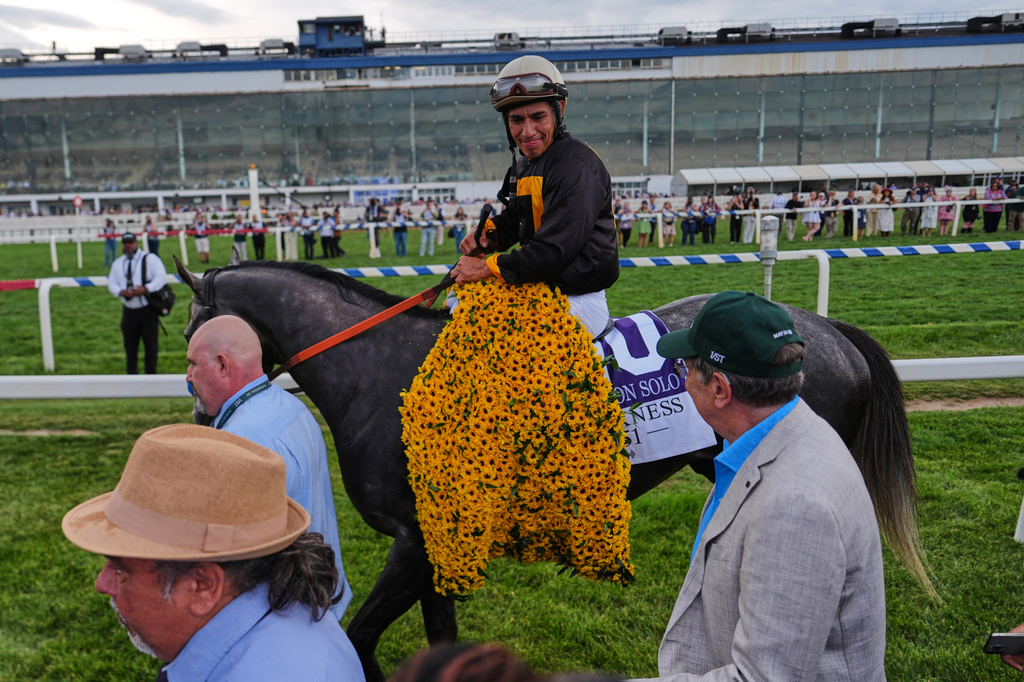 Paco Lopez is lead to the winners circle after he rode Napoleon Solo to win the 151st running of the Preakness Stakes horse race, Saturday, May 16, 2026, at Laurel Park in Laurel, Md. (AP Photo/Julia Demaree Nikhinson)