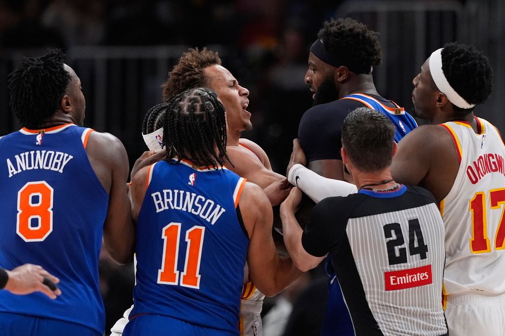 New York Knicks center Mitchell Robinson (23) and Atlanta Hawks guard Dyson Daniels (5) fight in the first half during Game 6 in a first-round NBA basketball playoffs series Thursday, April 30, 2026, in Atlanta. (AP Photo/Brynn Anderson)
