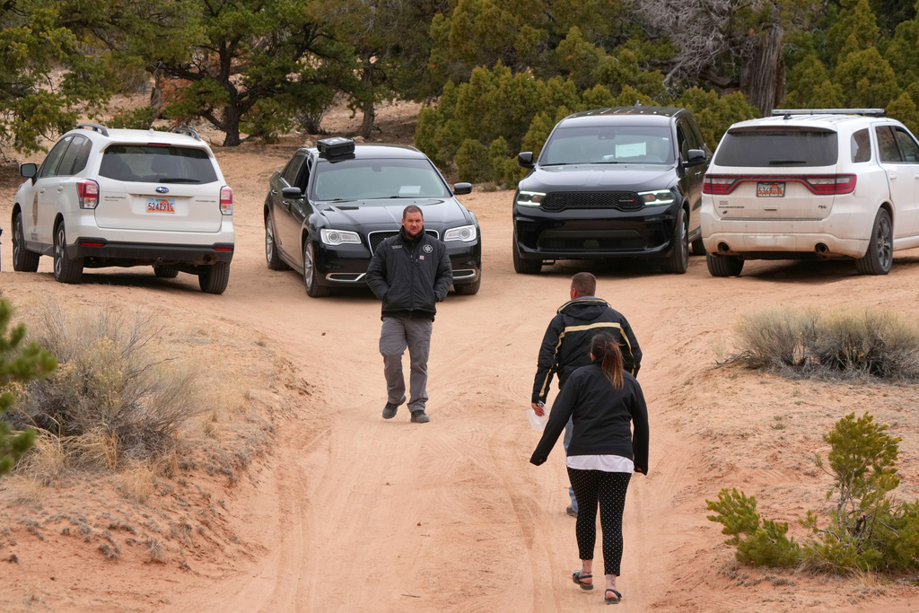 Authorities conduct an investigation Thursday, March 5, 2026, into the deaths of two women a day earlier on a trail just west of Capitol Reef National Park near Teasdale, Utah. (AP Photo/George Frey)