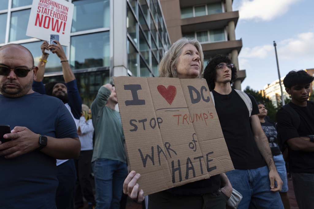 People rally against President Donald Trump's use of federal law enforcement and National Guard troops in Washington, Thursday, Aug. 21, 2025, in Washington. (AP Photo/Julia Demaree Nikhinson)
