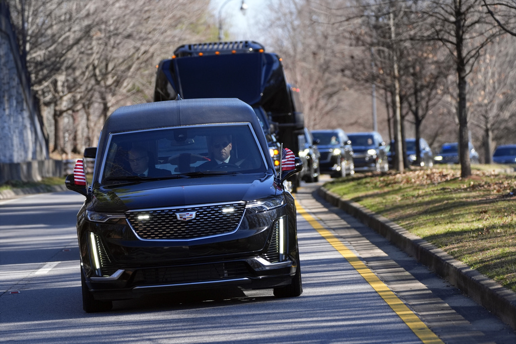The motorcade carrying the casket of former President Jimmy Carter departs the Jimmy Carter Presidential Library and Museum in Atlanta, Tuesday, Jan. 7, 2025. Carter died Dec. 29 at the age of 100. (AP Photo/Alex Brandon, Pool)