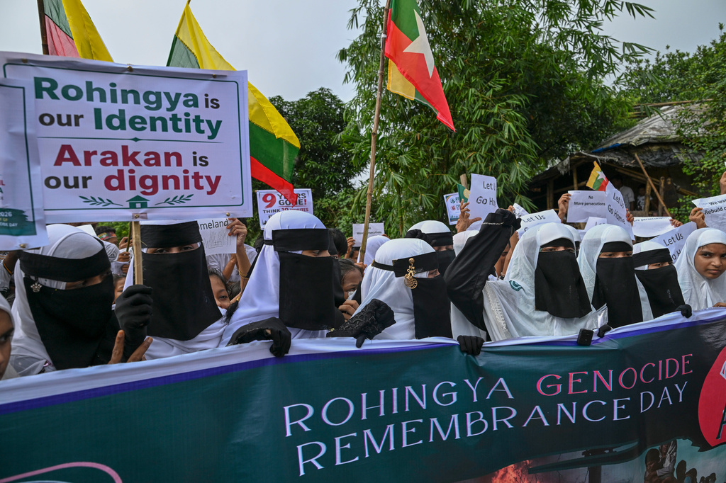 Rohingyas shout slogans during an event at a refugee camp in Cox's Bazar, Bangladesh, Tuesday, Aug. 25, 2026, marking the anniversary of the their exodus. (AP Photo/Abdul Goni)