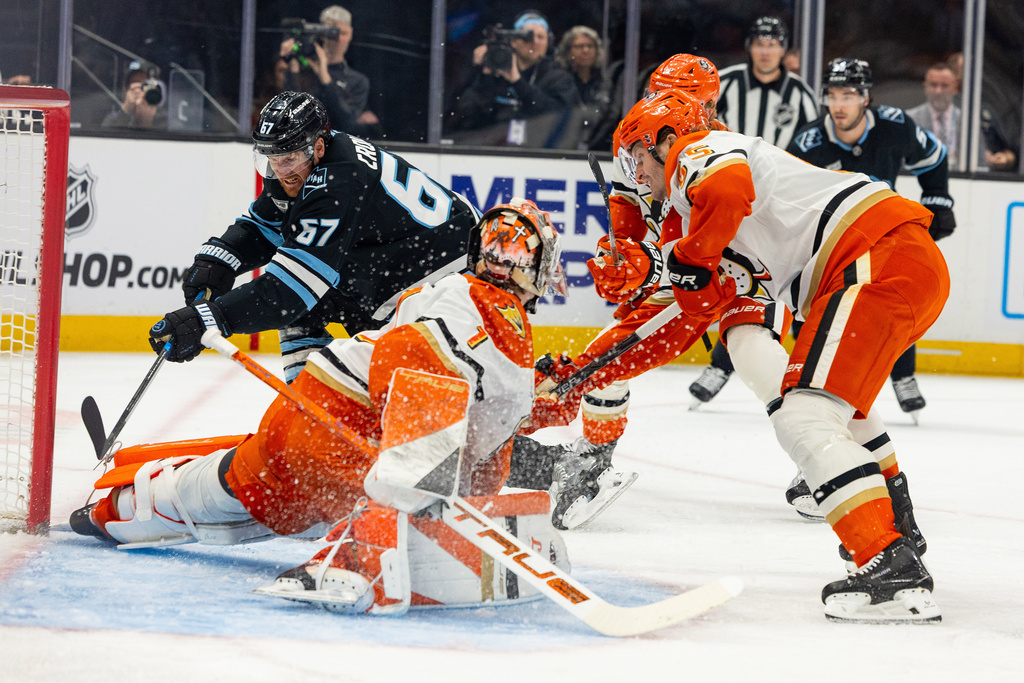 Utah Mammoth left wing Lawson Crouse (67) moves the puck to the goal but is blocked by Anaheim Ducks goalie Lukas Dostal (1) during the first period of an NHL hockey game, Friday, March 20, 2026, in Salt Lake City. (AP Photo/Melissa Majchrzak)