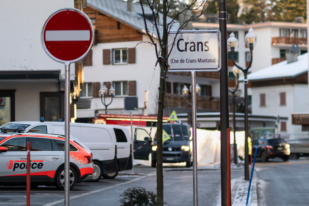 Police officers inspect the area where a fire broke out at the Le Constellation bar and lounge leaving people dead and injured, during New Year’s celebration, in Crans-Montana, Swiss Alps, Switzerland, Thursday, Jan. 1, 2026. (Alessandro della Valle/Keystone via AP)