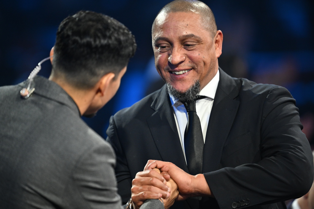 Former Brazil star Roberto Carlos is interviewed by actor Danny Ramirez during the draw for the 2026 soccer World Cup at the Kennedy Center in Washington, Friday, Dec. 5, 2025. (Mandel Ngan/Pool Photo via AP)