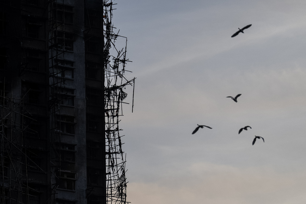 A burned building is seen at the scene of the fire that started Wednesday at Wang Fuk Court, a residential estate in the Tai Po district of Hong Kong's New Territories, Friday, Nov. 28, 2025. (AP Photo/Chan Long Hei)