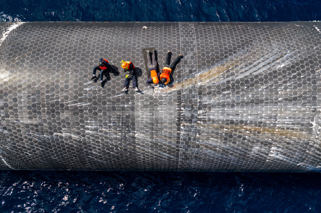 This image provided by SpaceX on Aug. 27, 2026, shows engineers inspecting Starship off the coast of Christmas Island in the Indian Ocean, following its launch on a test flight back in July. (SpaceX via AP)
