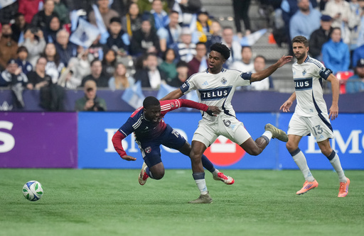 FC Dallas' Shaq Moore, left, and Vancouver Whitecaps' Ralph Priso, center, vie for the ball as Whitecaps' Thomas Muller, right, watches during the first half in Game 1 in the first round of MLS soccer's Western Conference playoffs in Vancouver, British Columbia, Sunday, Oct. 26, 2025. (Darryl Dyck/The Canadian Press via AP) FC Dallas' Shaq Moore, left, and Vancouver Whitecaps' Ralph Priso, center, vie for the ball as Whitecaps' Thomas Muller, right, watches during the first half in Game 1 in the first round of MLS soccer's Western Conference playoffs in Vancouver, British Columbia, Sunday, Oct. 26, 2025. (Darryl Dyck/The Canadian Press via AP)