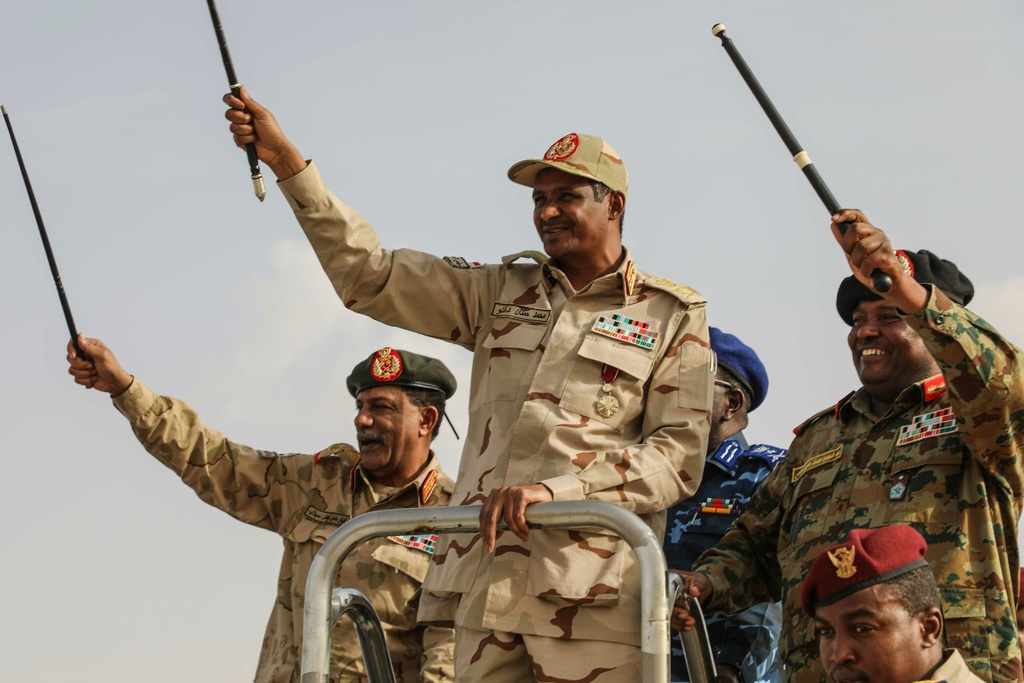 FILE - Gen. Mohammed Hamdan Dagalo, center, greets the crowd during a military-backed tribes' rally in the Nile River State of Sudan, July 13, 2019. (AP Photo/Mahmoud Hjaj, File)