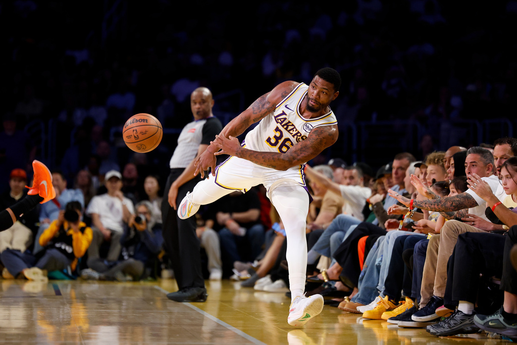 Los Angeles Lakers guard Marcus Smart (36) stops the ball from going out of bounds during the first half of an NBA basketball game against the New York Knicks, Sunday, March 8, 2026, in Los Angeles. (AP Photo/Caroline Brehman)