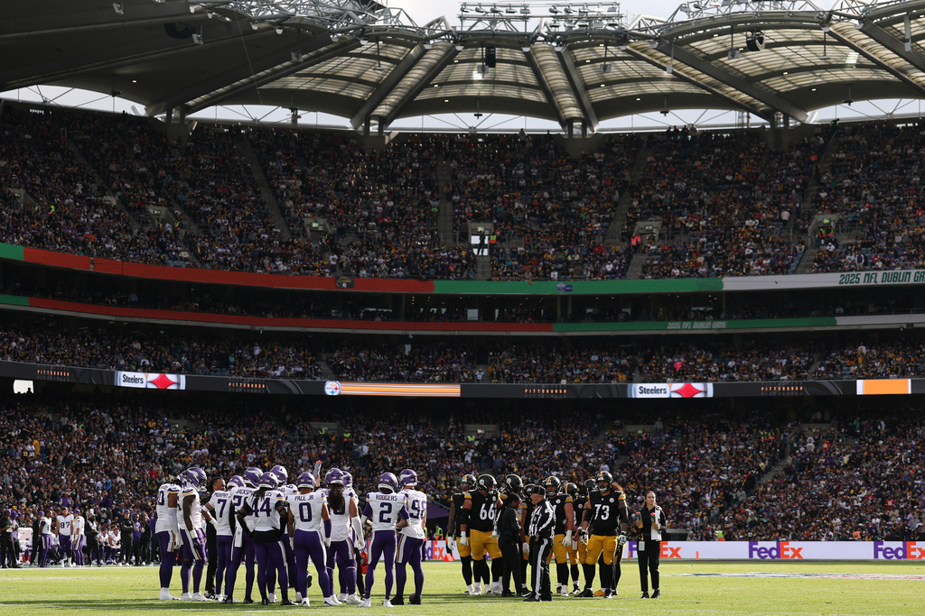 Players of both teams pause on the field during the NFL football game between Minnesota Vikings and Pittsburgh Steelers at Croke Park stadium in Dublin, Sunday, Sept. 28, 2025.(AP Photo/Ian Walton)