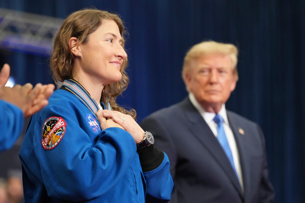Artemis II crew member Christina Koch reacts after President Donald Trump, right, presented her with the Congressional Space Medal of Honor, Friday, Aug. 28, 2026, at Johnson Space Center in Houston. (AP Photo/Mark Schiefelbein)