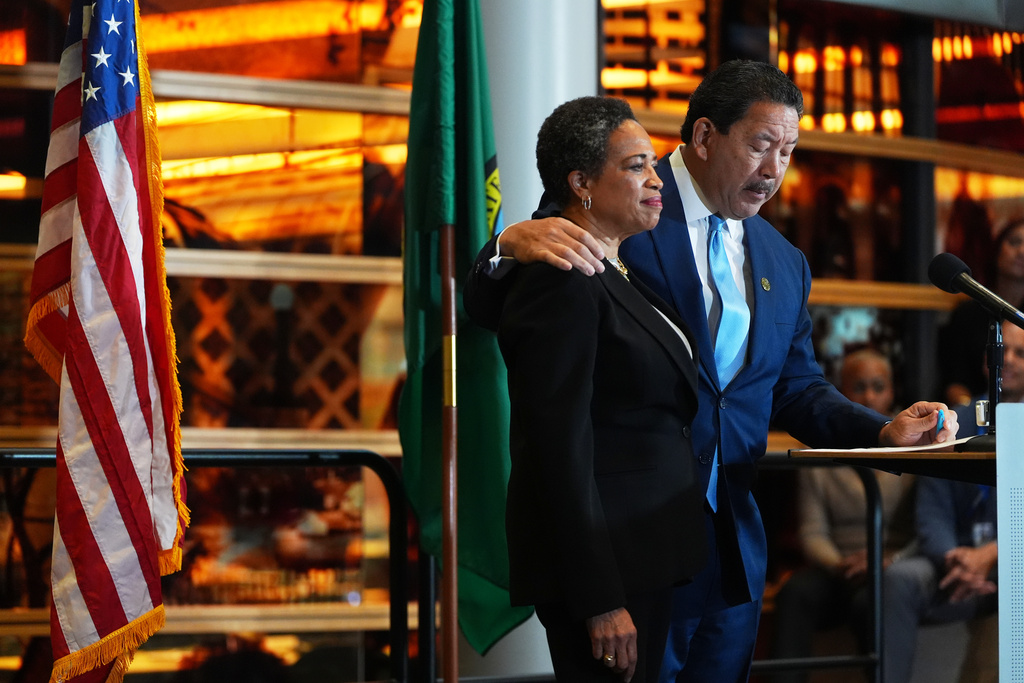 Seattle Mayor Bruce Harrell puts an arm around wife Joanne Harrell during his concession speech at Seattle City Hall Thursday, Nov. 13, 2025, in Seattle. (AP Photo/Lindsey Wasson)