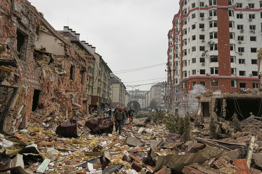 People walk near apartment buildings damaged after a Russian attack in Kyiv, Ukraine, Sunday, Sept. 28, 2025. (AP Photo/Efrem Lukatsky) People walk near apartment buildings damaged after a Russian attack in Kyiv, Ukraine, Sunday, Sept. 28, 2025. (AP Photo/Efrem Lukatsky)