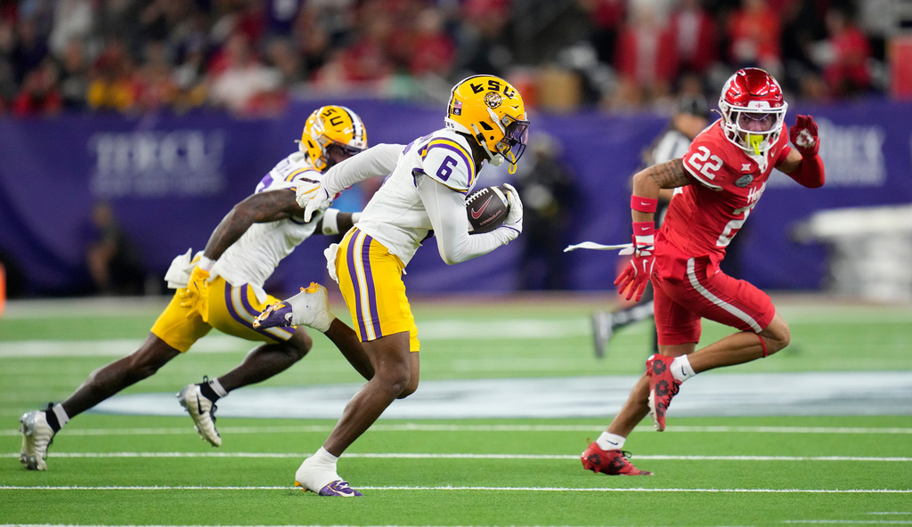 LSU wide receiver Barion Brown (6) runs the ball on a kickoff return against Houston defensive back Marc Stampley II (22) which resulted in a touchdown during the first half of the Kinder's Texas Bowl NCAA football game, Saturday, Dec. 27, 2025, in Houston. (AP Photo/Karen Warren)