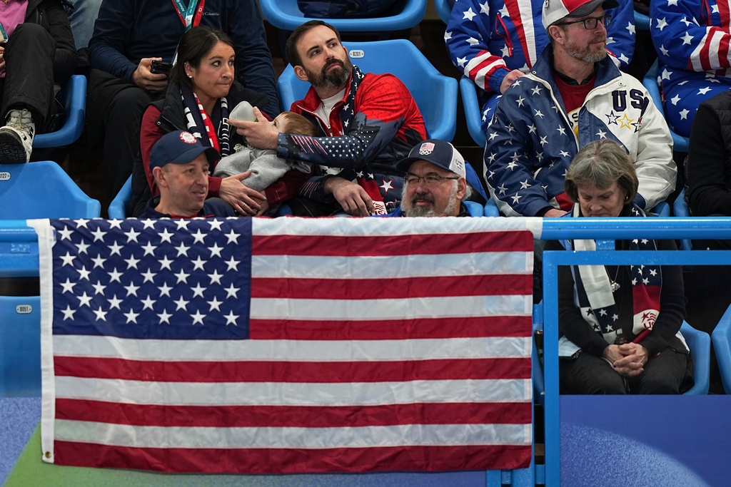 US supporters watch during the gold medal mixed doubles curling match between USA and Sweden, at the 2026 Winter Olympics, in Cortina D'Ampezzo, Italy, Tuesday, Feb. 10, 2026. (AP Photo/Fatima Shbair)