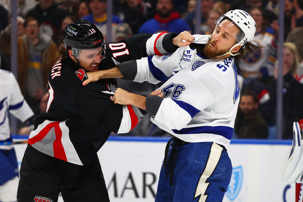 Buffalo Sabres center Sam Carrick (10) and Tampa Bay Lightning right wing Scott Sabourin (46) fight during the first period of an NHL hockey game, Sunday, March 8, 2026, in Buffalo, N.Y. (AP Photo/Jeffrey T. Barnes)