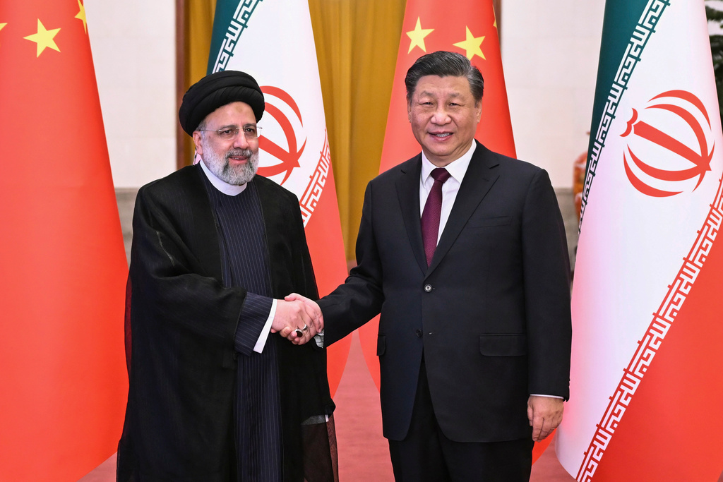 FILE - In this photo released by Xinhua News Agency, Visiting Iranian President Ebrahim Raisi, left, shakes hands with Chinese President Xi Jinping before their meeting at the Great Hall of the People in Beijing, China, Feb. 14, 2023. (Yan Yan/Xinhua via AP, File)