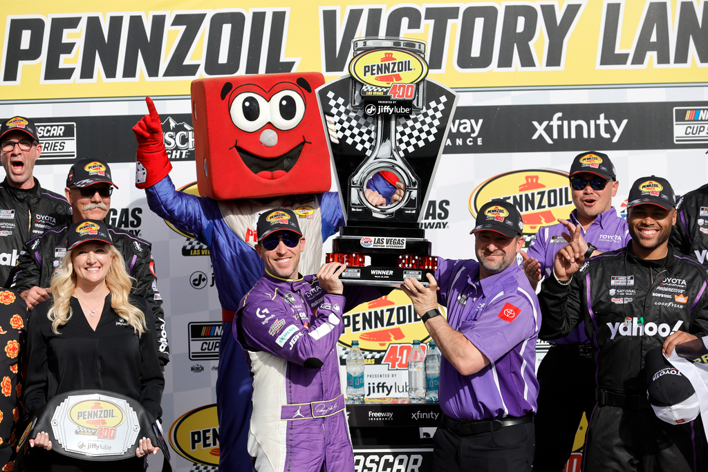 Denny Hamlin, left, holds up the trophy with a teammate after winning a NASCAR Cup Series auto race at Las Vegas Motor Speedway, Sunday, March 15, 2026, in Las Vegas. (AP Photo/Steve Marcus)