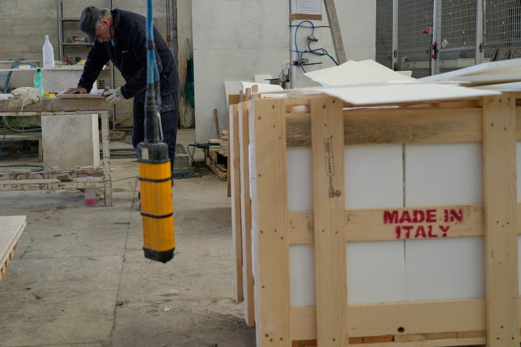 A man sands and polishes a slab of travertine at the Mariotti Carlo SpA stonecutting firm near Tivoli, Italy, 35 kilometers east of Rome, on Friday, Feb. 13, 2026, that will be used to adorn the new Manhattan temple in New York City. (AP Photo/Gregorio Borgia)
